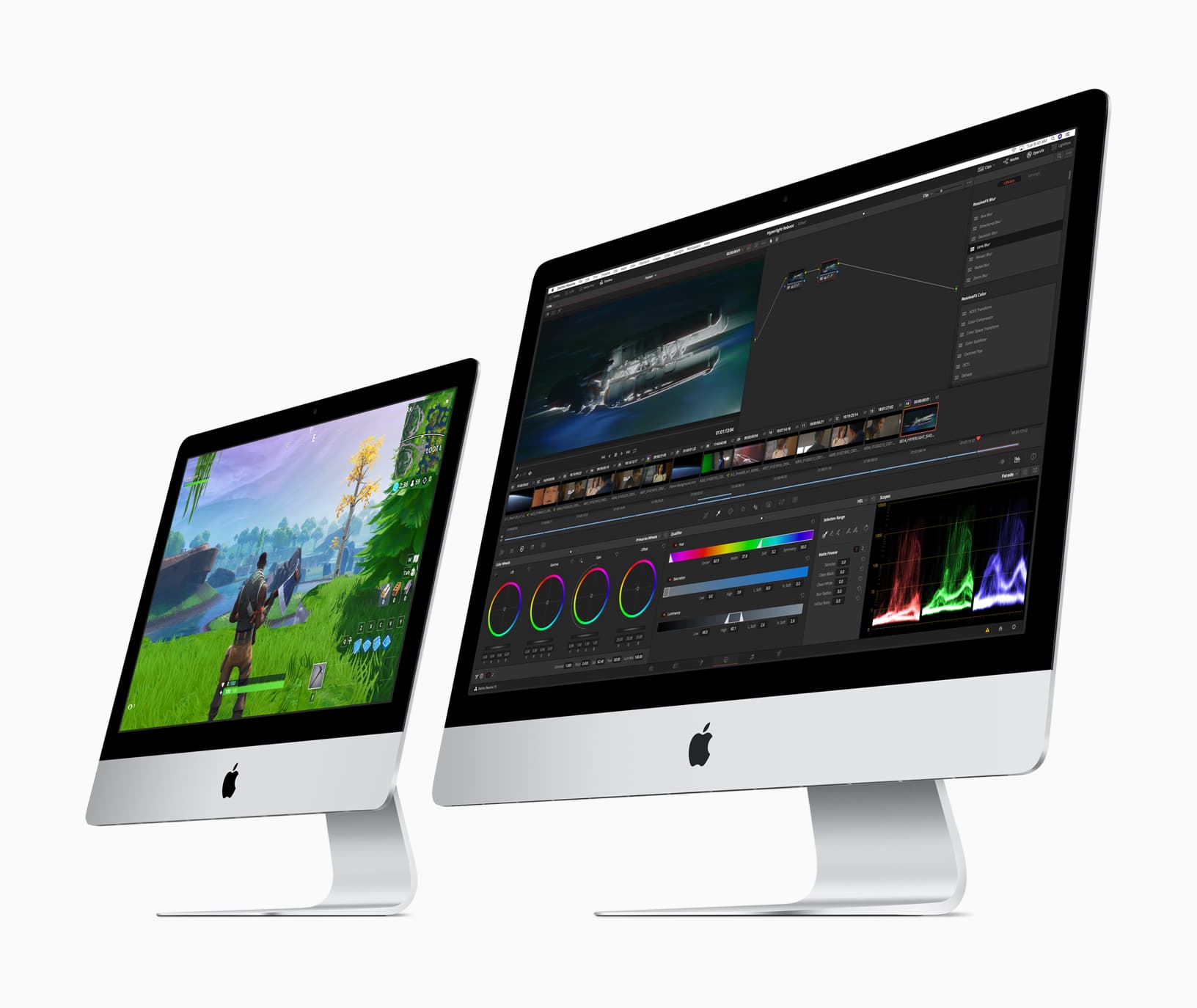 Two silver iMacs from Apple's March 2019 press material, turned slightly to the left on a white background: the smaller 21.5-inch model in front shows a video game character standing in a grassy field, and the larger 27-inch model behind it shows a video-editing timeline with color wheels and scopes.