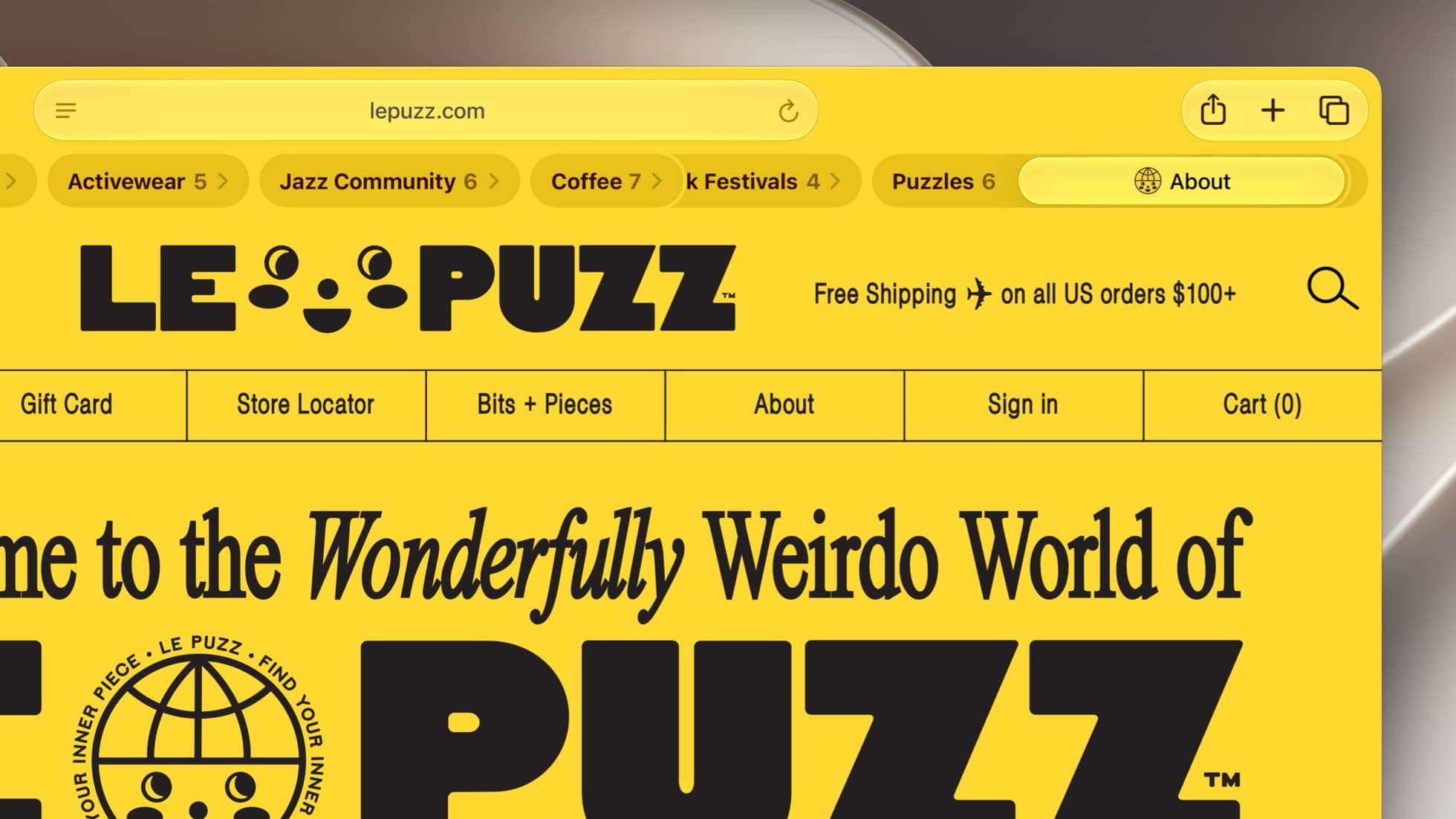 A close crop of a Safari window in macOS 27 showing the yellow Le Puzz store page; under the address bar, the tabs are grouped into labelled pills reading Activewear 5, Jazz Community 6, Coffee 7, Festivals 4 and Puzzles 6.