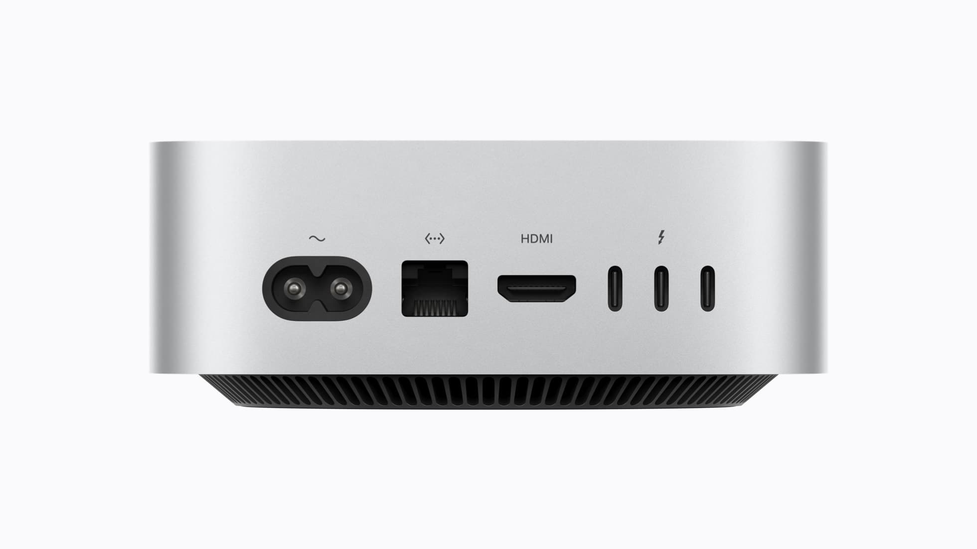 The back of a silver Mac mini against a white background, showing from left a two-prong power inlet, an Ethernet port, an HDMI port and three Thunderbolt ports in a row, with the black vented base below.